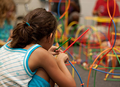 Child building with straws